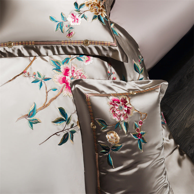 Embroidered pillow with floral design on a neutral background