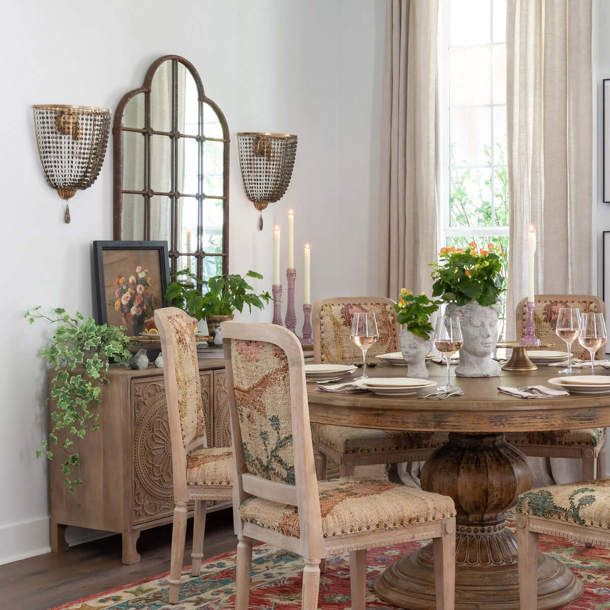 Dining room with wooden table, chairs, and decorative elements.