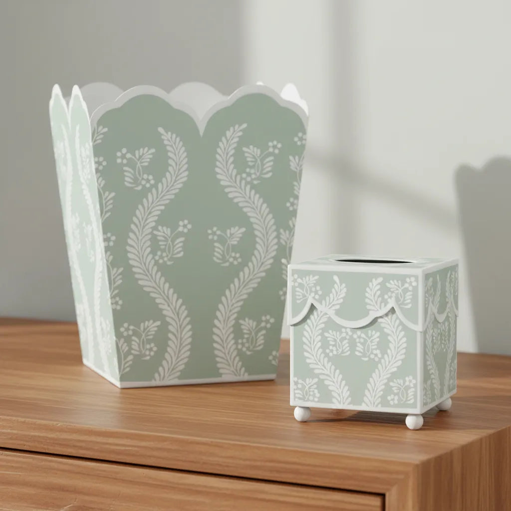 Decorative sage green floral patterned trash can and tissue holder on a wooden surface.