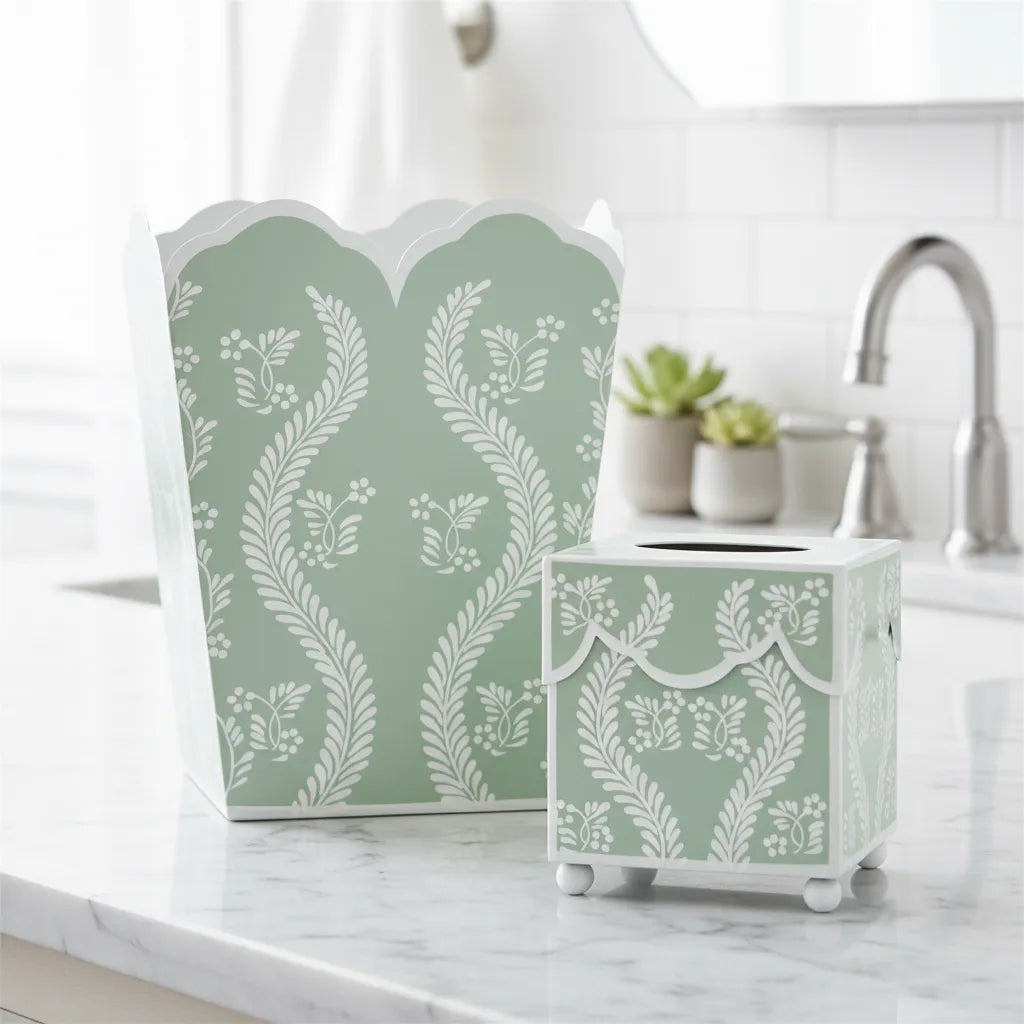 Decorative sage green trash can with floral pattern on a kitchen counter