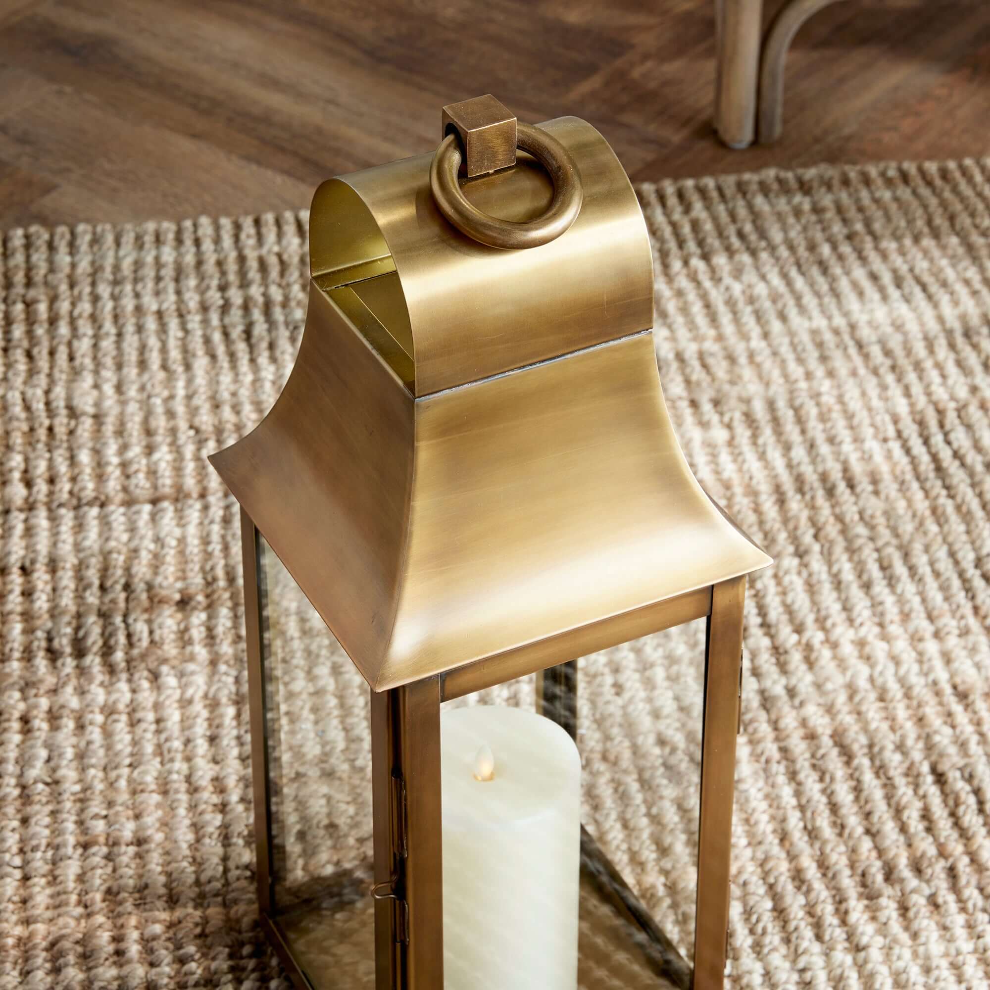 Brass candle holder with a candle on a textured surface