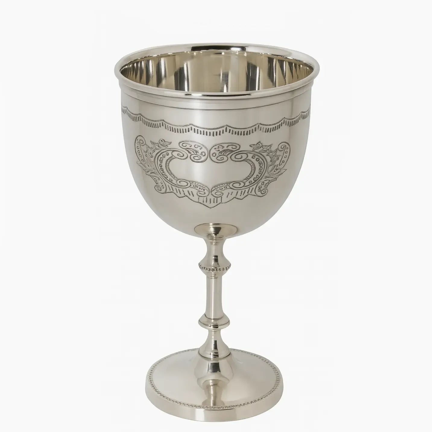 Silver plated chalice goblet with intricate engravings on a white background