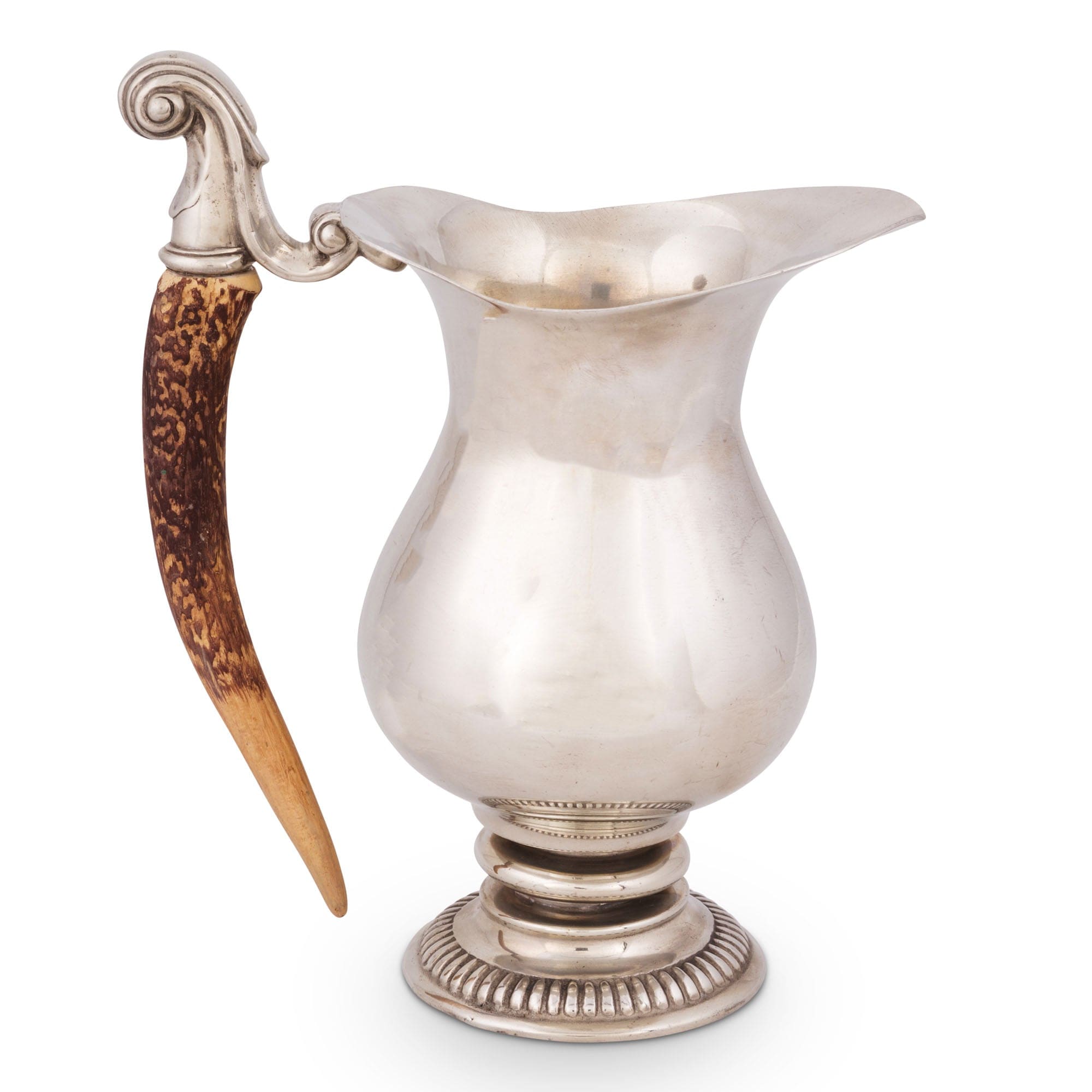 Silver pitcher with a decorative handle on a white background