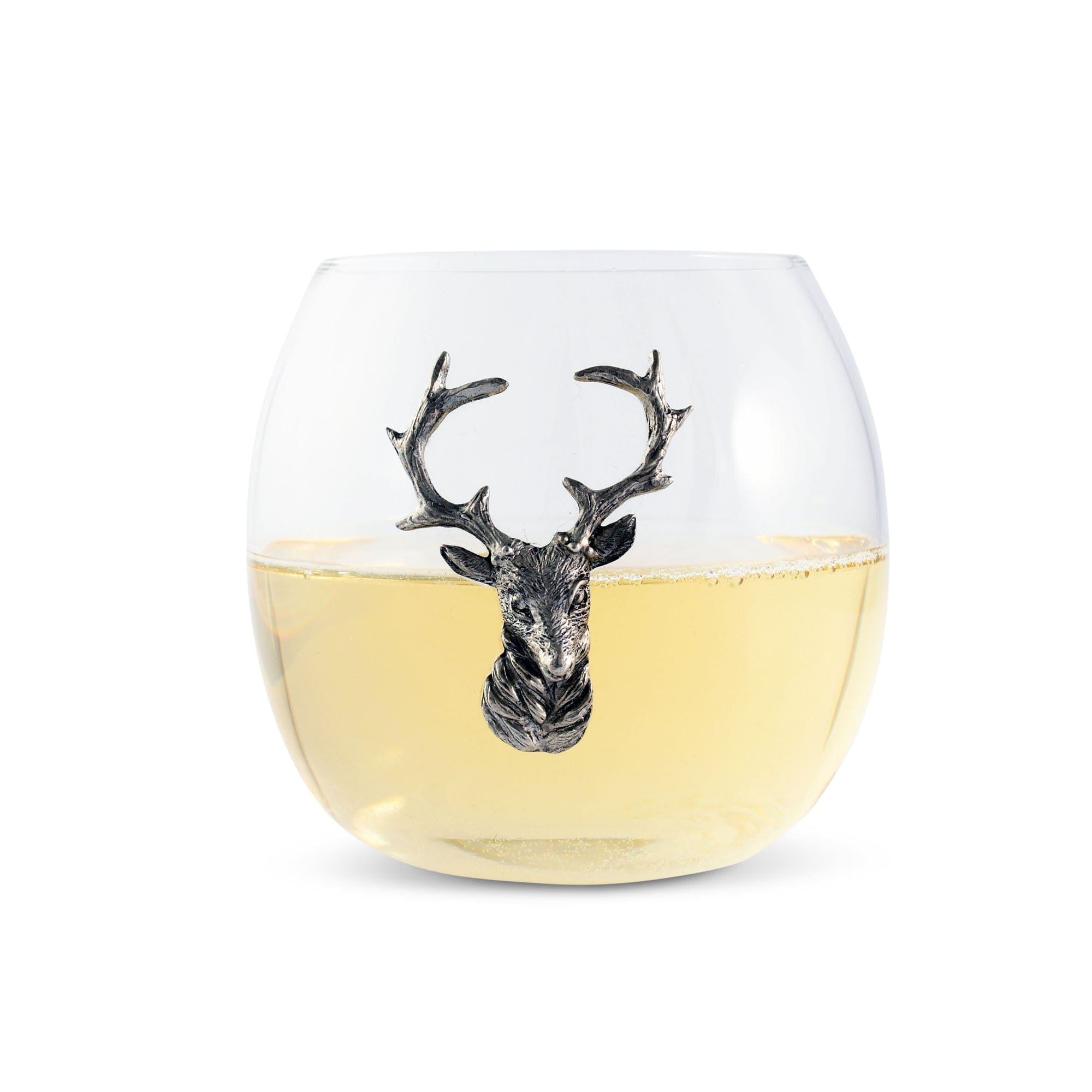 Clear glass with deer head design filled with white wine on a white background
