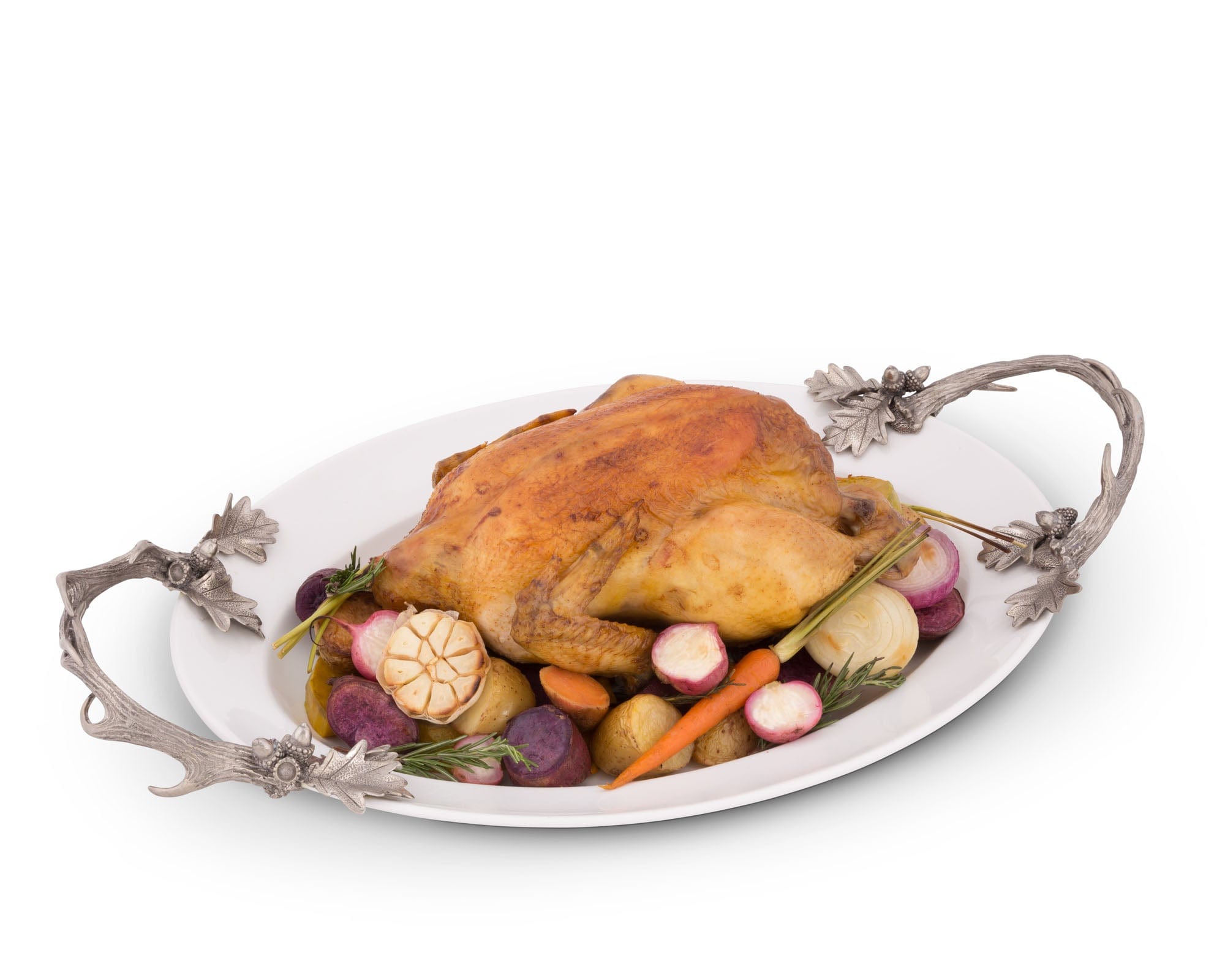 Roasted chicken with vegetables on a decorative platter with silver handles.