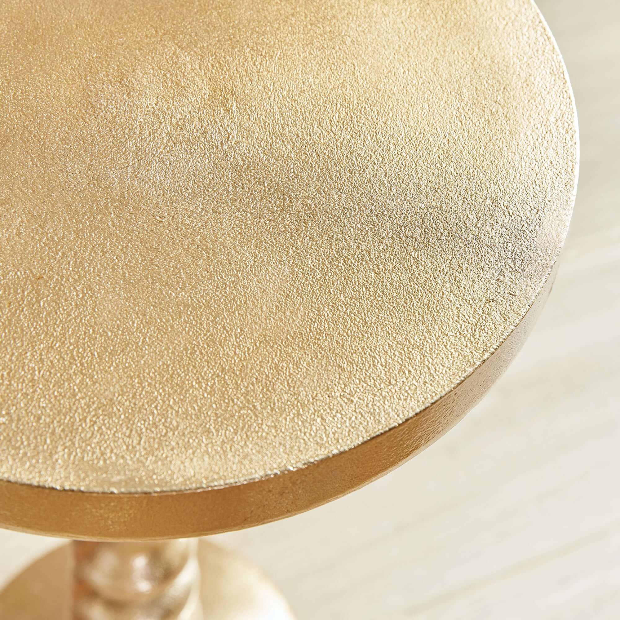 Close-up of a textured gold surface with a blurred background