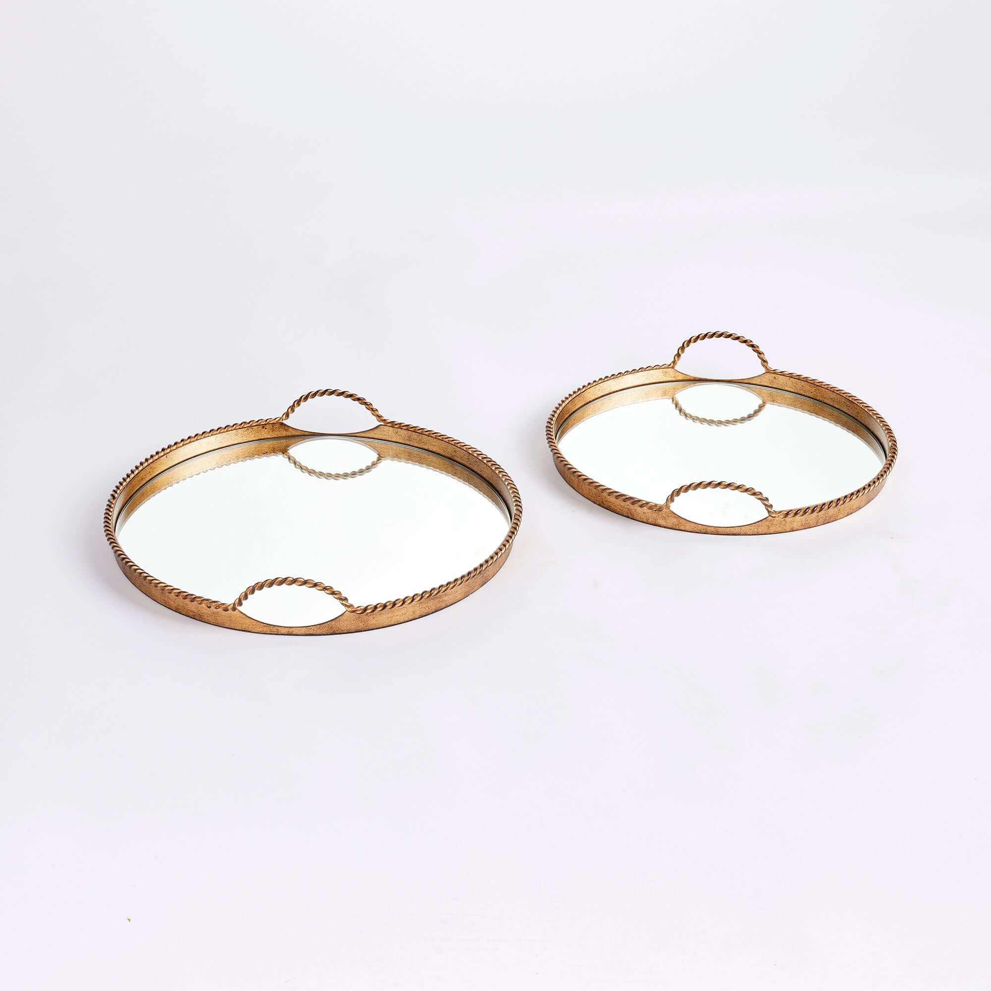 Two gold decorative trays on a white background