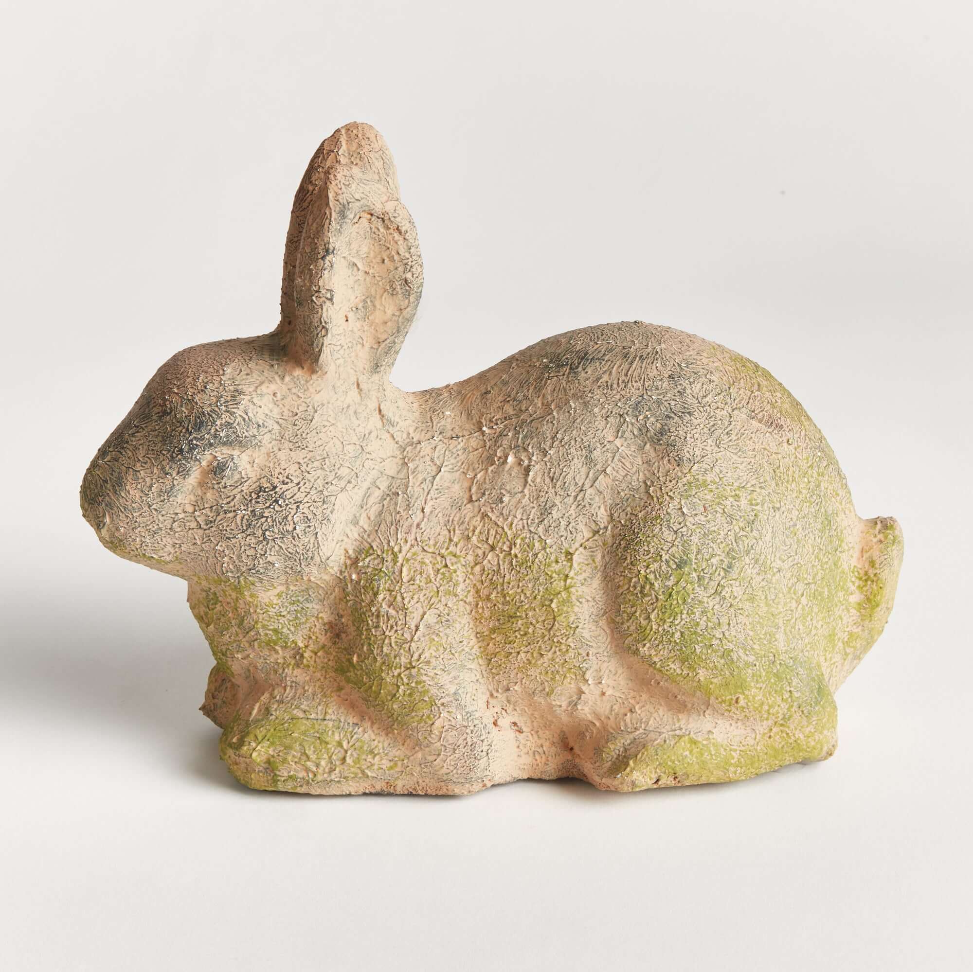 Ceramic rabbit sculpture with a textured surface on a white background