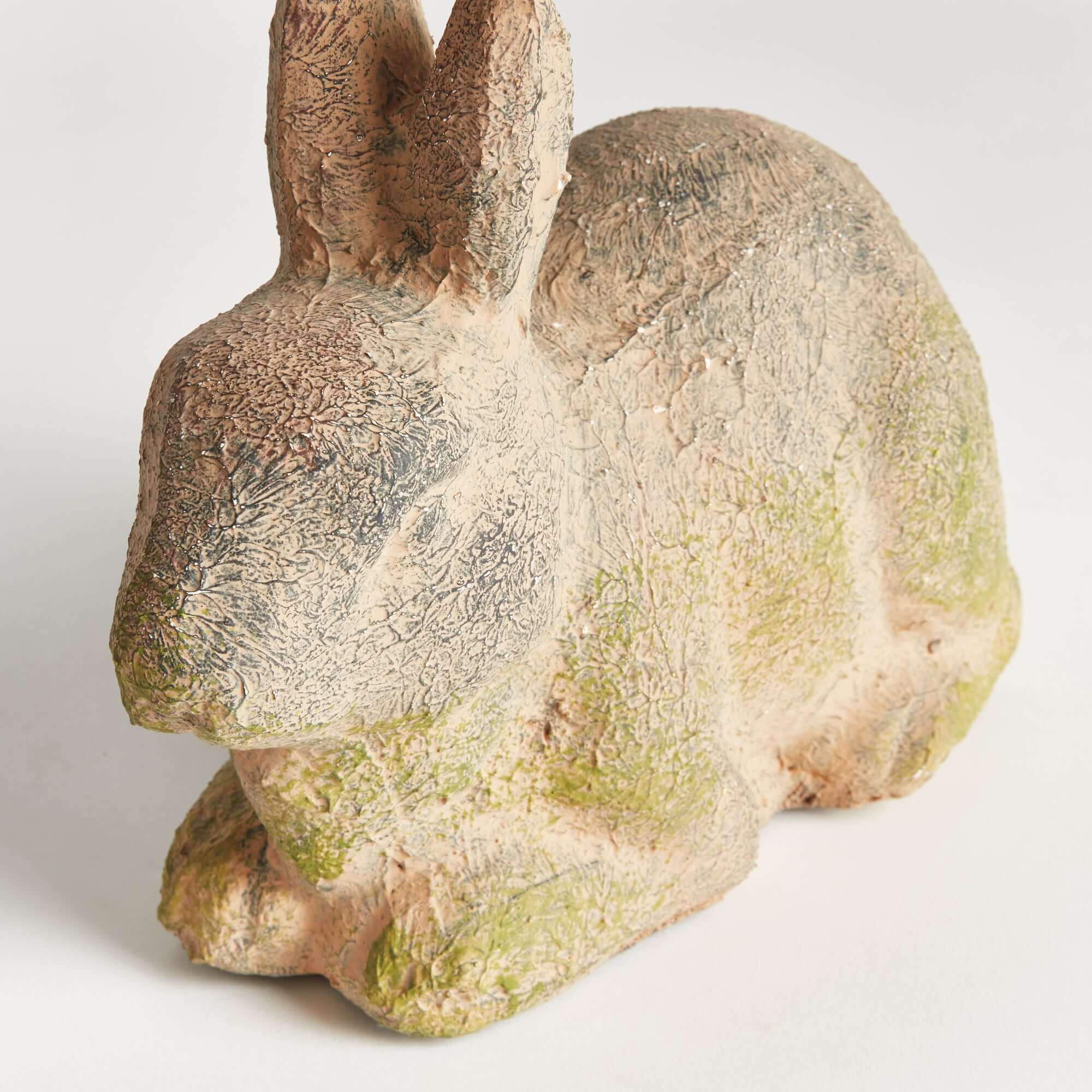 Stone sculpture of a rabbit on a white background