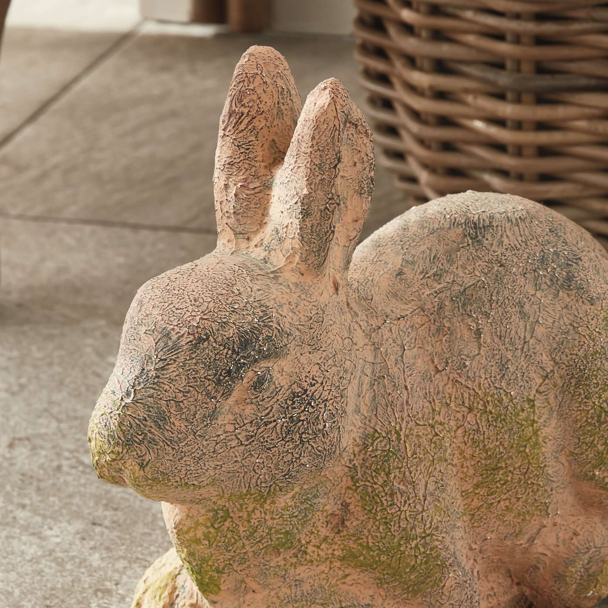 Stone rabbit sculpture on a textured surface